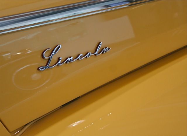 Banana yellow Lincoln car with stylish Lincoln script