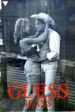 Guess Jeans ad with guy wearing cowboy hat and girl in shorts