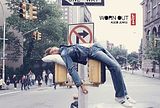 Person in jeans sleeping on crosswalk lights