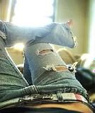 Girl laying down in ripped jeans