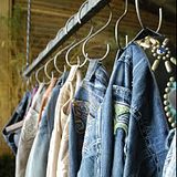 Jeans hanging from hooks on a rack