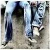 two people sitting in jeans